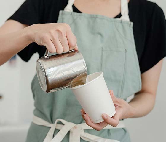 Lady making a latte in a coffee shop