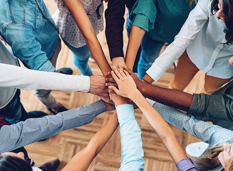 A community group with all hands in