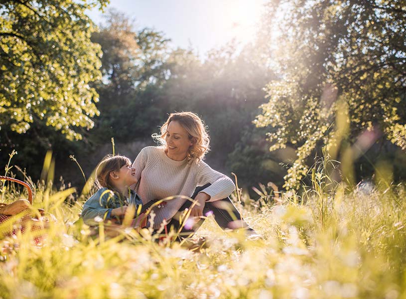A mother and daughter talking in a field