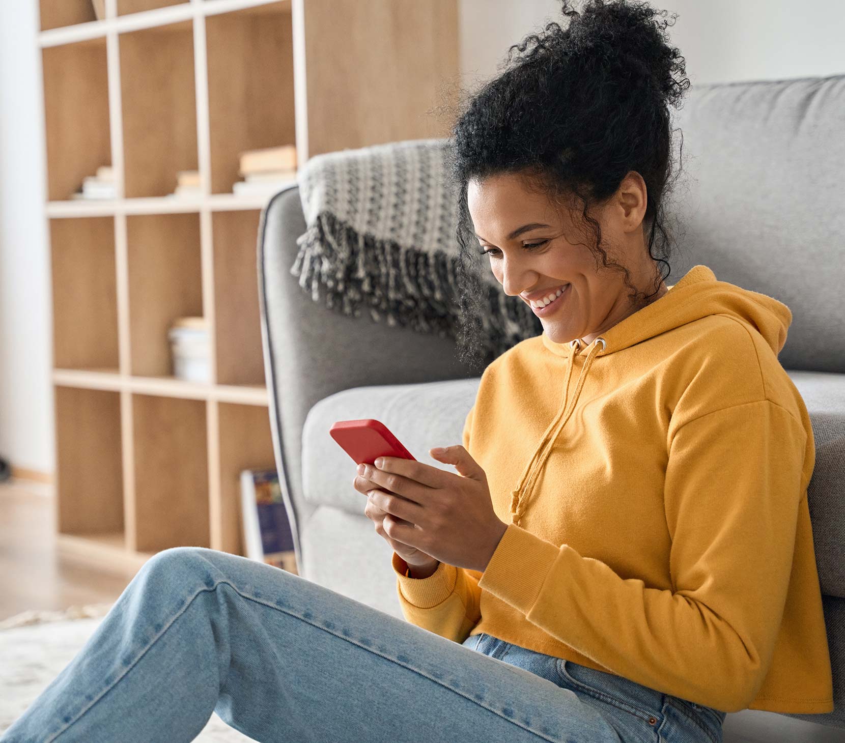 Young lady in her home using a smartphone