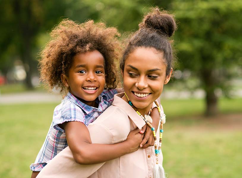 A mother and child playing in a park