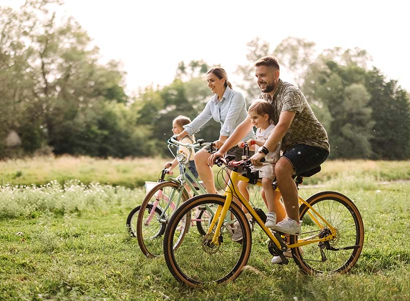 A young family on a bike ride in a field