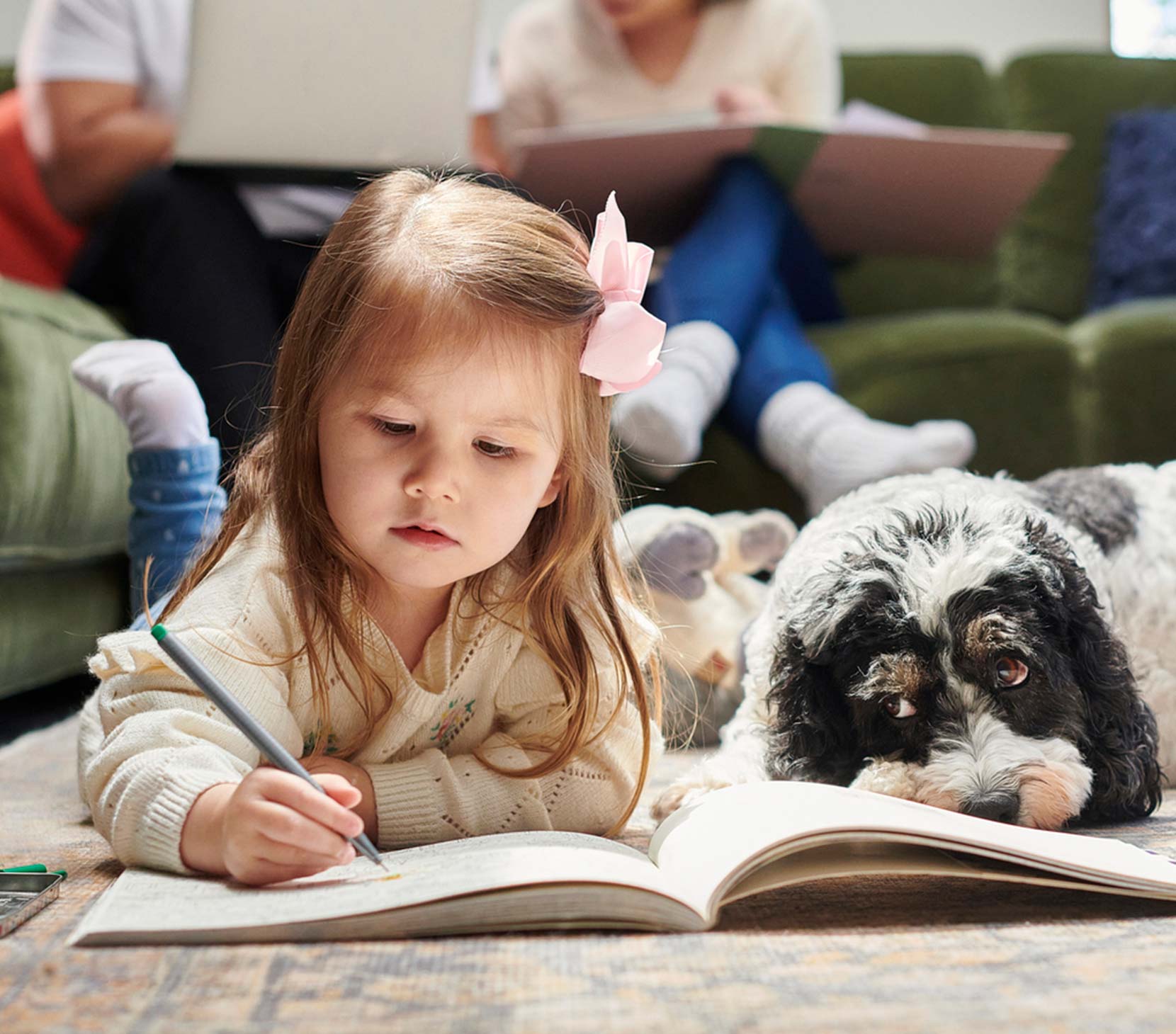 Little girl with her dog and family in their home